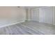 Bedroom featuring wood floors, closet, and window with blinds at 6700 Roswell Rd # 21E, Sandy Springs, GA 30328