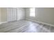 Bedroom with wood-look floors, natural light, and closet at 6700 Roswell Rd # 21E, Sandy Springs, GA 30328