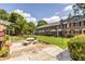 Exterior view of townhomes with manicured lawn and patio at 6700 Roswell Rd # 21E, Sandy Springs, GA 30328
