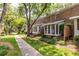 Exterior view of townhomes with manicured lawn at 6700 Roswell Rd # 21E, Sandy Springs, GA 30328