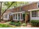 Exterior of brick home with sunroom and landscaped front at 6700 Roswell Rd # 21E, Sandy Springs, GA 30328