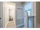 Hallway with bathroom access; upper floor stairs and railing at 6700 Roswell Rd # 21E, Sandy Springs, GA 30328