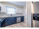 Well-lit kitchen with stainless steel appliances, and blue and white cabinets at 6700 Roswell Rd # 21E, Sandy Springs, GA 30328
