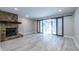 Spacious living room with hardwood floors, fireplace, and sliding doors to the sunroom at 6700 Roswell Rd # 21E, Sandy Springs, GA 30328