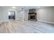 Living room featuring hardwood floors, fireplace, and open doorway to the kitchen at 6700 Roswell Rd # 21E, Sandy Springs, GA 30328