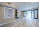 Open living area with modern sliding doors, stone fireplace, and modern paint at 6700 Roswell Rd # 21E, Sandy Springs, GA 30328