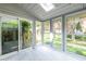Sunroom with tile floors and wall-to-wall windows offering views of the surrounding yard at 6700 Roswell Rd # 21E, Sandy Springs, GA 30328