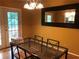 Dining room with glass table, yellow walls and access to backyard at 3034 Kent Ct, Duluth, GA 30096