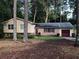 Charming single-story home with brick accents, complemented by a well-manicured lawn and mature trees at 3034 Kent Ct, Duluth, GA 30096