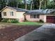 Charming single-story home with brick accents, complemented by a well-manicured lawn and mature trees at 3034 Kent Ct, Duluth, GA 30096