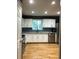 Bright kitchen featuring stainless steel appliances, sleek cabinetry, and hardwood floors at 3034 Kent Ct, Duluth, GA 30096
