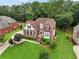 Beautiful aerial view of a brick home showcasing its landscaped yard and surrounding greenery at 3223 Thornecreek Dr, Douglasville, GA 30135