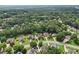 Aerial view of homes in a tree-filled suburban neighborhood at 3223 Thornecreek Dr, Douglasville, GA 30135