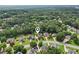 Wide aerial view of a suburban neighborhood with tree-lined streets and well-maintained homes at 3223 Thornecreek Dr, Douglasville, GA 30135