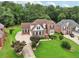 Lovely two-story brick home with lush lawn, mature trees, and paved driveway at 3223 Thornecreek Dr, Douglasville, GA 30135