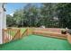 Wooden deck with built-in benches, steps down to the yard and trees at 3223 Thornecreek Dr, Douglasville, GA 30135