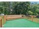 Wooden deck with built-in benches and view of the wooded backyard at 3223 Thornecreek Dr, Douglasville, GA 30135