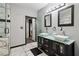 Contemporary bathroom featuring double vessel sinks, sleek cabinetry, a walk-in shower and modern fixtures at 3223 Thornecreek Dr, Douglasville, GA 30135