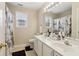 Bathroom with dual sinks, large mirror, shower curtain and good light at 3223 Thornecreek Dr, Douglasville, GA 30135