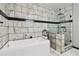 Bright bathroom featuring a soaking tub and separate glass enclosed shower with unique tiling at 3223 Thornecreek Dr, Douglasville, GA 30135