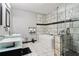 Modern bathroom featuring a marble tile walk-in shower, a luxurious soaking tub, and sleek vessel sinks at 3223 Thornecreek Dr, Douglasville, GA 30135