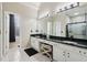 Bright bathroom featuring double sinks, vanity with sleek countertops and modern fixtures at 3223 Thornecreek Dr, Douglasville, GA 30135