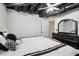 Finished basement bedroom featuring luxury bedding and modern black furniture at 3223 Thornecreek Dr, Douglasville, GA 30135