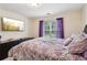 Bedroom featuring a patterned comforter, purple curtains, and a TV at 3223 Thornecreek Dr, Douglasville, GA 30135