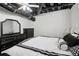 Finished basement bedroom with luxury bedding and contemporary black furniture at 3223 Thornecreek Dr, Douglasville, GA 30135