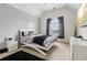 Bright bedroom featuring a vaulted ceiling, a cozy bed with a black rug and a large window for natural light at 3223 Thornecreek Dr, Douglasville, GA 30135