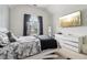 Bright bedroom featuring a vaulted ceiling, a cozy bed with a black rug and a large window for natural light at 3223 Thornecreek Dr, Douglasville, GA 30135