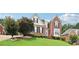 Beautiful two-story home with brick exterior, manicured lawn, mature landscaping, and a welcoming entrance at 3223 Thornecreek Dr, Douglasville, GA 30135
