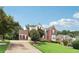 Traditional-style home with mature trees, professionally landscaped yard and long driveway at 3223 Thornecreek Dr, Douglasville, GA 30135