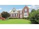 Charming two-story brick home with lush green lawn and manicured landscaping at 3223 Thornecreek Dr, Douglasville, GA 30135