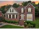 Inviting two-story brick home featuring classic architecture and landscaped front yard at 3223 Thornecreek Dr, Douglasville, GA 30135