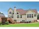 Beautiful home exterior with a deck, patio, well-maintained lawn, and mature landscaping at 3223 Thornecreek Dr, Douglasville, GA 30135