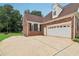 Home exterior featuring a brick facade, two-car garage, and well-manicured lawn at 3223 Thornecreek Dr, Douglasville, GA 30135