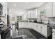 Spacious kitchen featuring white cabinets, black countertops, and stainless steel appliances at 3223 Thornecreek Dr, Douglasville, GA 30135