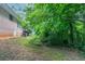 Home exterior features a brick facade, basement access, wooden deck and large backyard at 460 E Kildare Nw Ave, Atlanta, GA 30318
