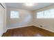 Bedroom with hardwood floors, two windows, and neutral decor at 460 E Kildare Nw Ave, Atlanta, GA 30318