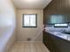 Compact kitchen with a window, dark wood cabinets, and a practical layout, ready for renovation at 460 E Kildare Nw Ave, Atlanta, GA 30318