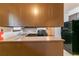 Kitchen with dark cabinetry, a breakfast bar, stainless steel sink, and black refrigerator at 460 E Kildare Nw Ave, Atlanta, GA 30318