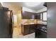 Kitchen features classic appliances, dark cabinetry, and tile flooring, awaiting modern updates at 460 E Kildare Nw Ave, Atlanta, GA 30318