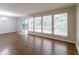 Spacious living room with hardwood floors, large windows and sliding glass door, offering natural light at 460 E Kildare Nw Ave, Atlanta, GA 30318