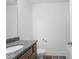 A bathroom featuring a gray granite countertop, toilet, shower with white tile and brown plank flooring at 5316 Radford Loop, Fairburn, GA 30213