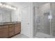 Bathroom with granite countertop vanity, a stylish shower with glass door and sleek fixtures at 5316 Radford Loop, Fairburn, GA 30213