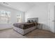 A bedroom with vaulted ceilings, carpet floors, white walls and a large bed with matching furniture at 5316 Radford Loop, Fairburn, GA 30213