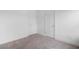 A bedroom featuring carpet floors, white walls and trim and multiple closet doors at 5316 Radford Loop, Fairburn, GA 30213