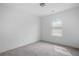 A bedroom featuring carpet floors, white walls and trim with a window and lighting fixture at 5316 Radford Loop, Fairburn, GA 30213