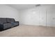 A bonus room featuring a comfortable reclining sofa, perfect for relaxation, with multiple entry doors at 5316 Radford Loop, Fairburn, GA 30213